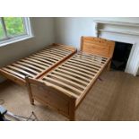 A pine framed single bed with slide out