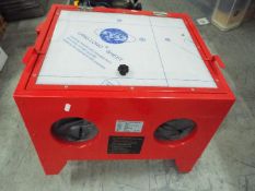 A sand blasting cabinet, approximately 4