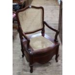 Mahogany framed bergere back and seat commode armchair.
