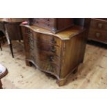 Mahogany serpentine front chest of four graduated oak lined drawers on bracket feet,