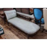 Edwardian carved framed and upholstered chaise longue on turned legs.