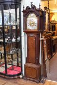 Antique oak and mahogany eight day longcase clock having brass and silvered arched dial signed
