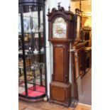 Antique oak and mahogany eight day longcase clock having brass and silvered arched dial signed