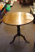 19th Century circular mahogany snap top table on turned column and pad feet, 74cm diameter.