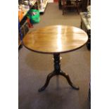 19th Century circular mahogany snap top table on turned column and pad feet, 74cm diameter.