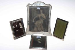 Four silver mounted photograph frames, the largest (worn) 25cm by 20cm.