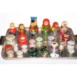 Sixteen enamel boxes including eight Halcyon Days, two Chinese frog boxes, and six Russian dolls.