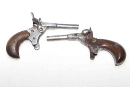 Two antique muff pistols, 11.5cm length. Condition: The one on the left has inscription PAT.6254.13.