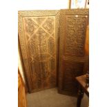 Three Persian design carved teak panels, largest piece 163 by 80 cm.