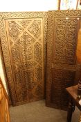 Three Persian design carved teak panels, largest piece 163 by 80 cm.