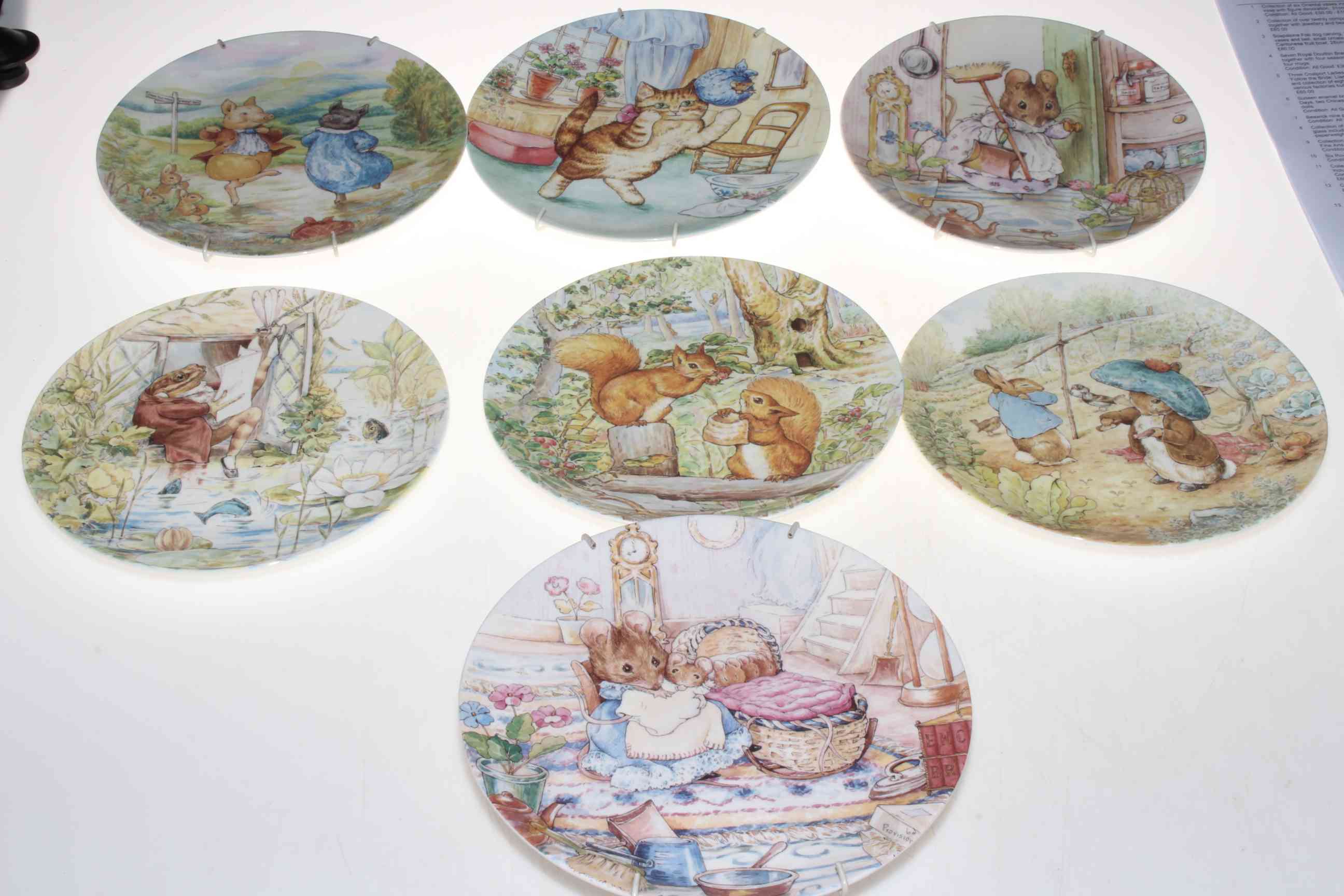 Seven Wedgwood Beatrix Potter collectors plates, Royal Doulton Bunnykins and Snowman wall clocks, - Image 2 of 2