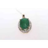 Emerald and diamond pendant with 5.6 carat oval emerald bordered with 0.