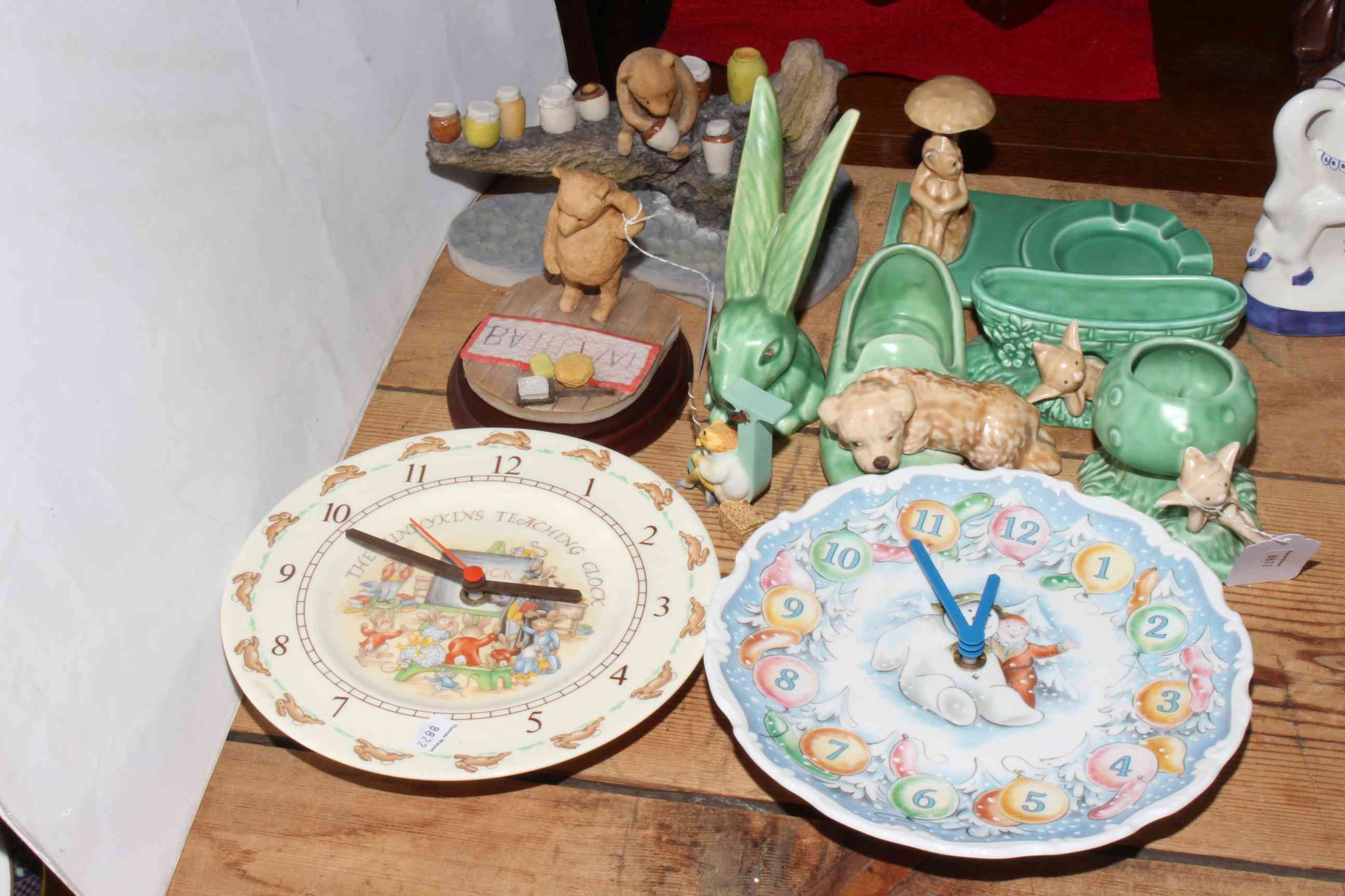 Seven Wedgwood Beatrix Potter collectors plates, Royal Doulton Bunnykins and Snowman wall clocks,