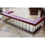 Good quality club fender, the oak base supporting reeded brass supports to studded red leather seat,