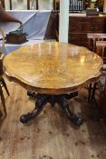 Victorian figured walnut shaped top loo table on central pedestal fo four scrolled legs,
