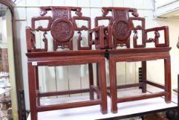 Pair of Chinese hardwood elbow chairs.