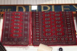 Eastern red ground wool runner, and two wool rugs (3).