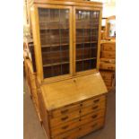 Oak leaded glass door, and four drawer bureau bookcase 92cm wide, 195cm high, 50cm deep.