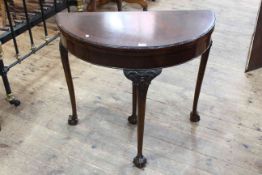 Mahogany demi-lune fold top card table on carved cabriole legs.