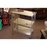 Art Deco painted wrought iron trolley with glass shelves, 70cm wide.
