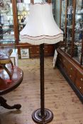 Heavily carved camphor wood standard lamp with silk shade.