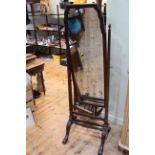 Mahogany cheval mirror raised on square tapering supports.