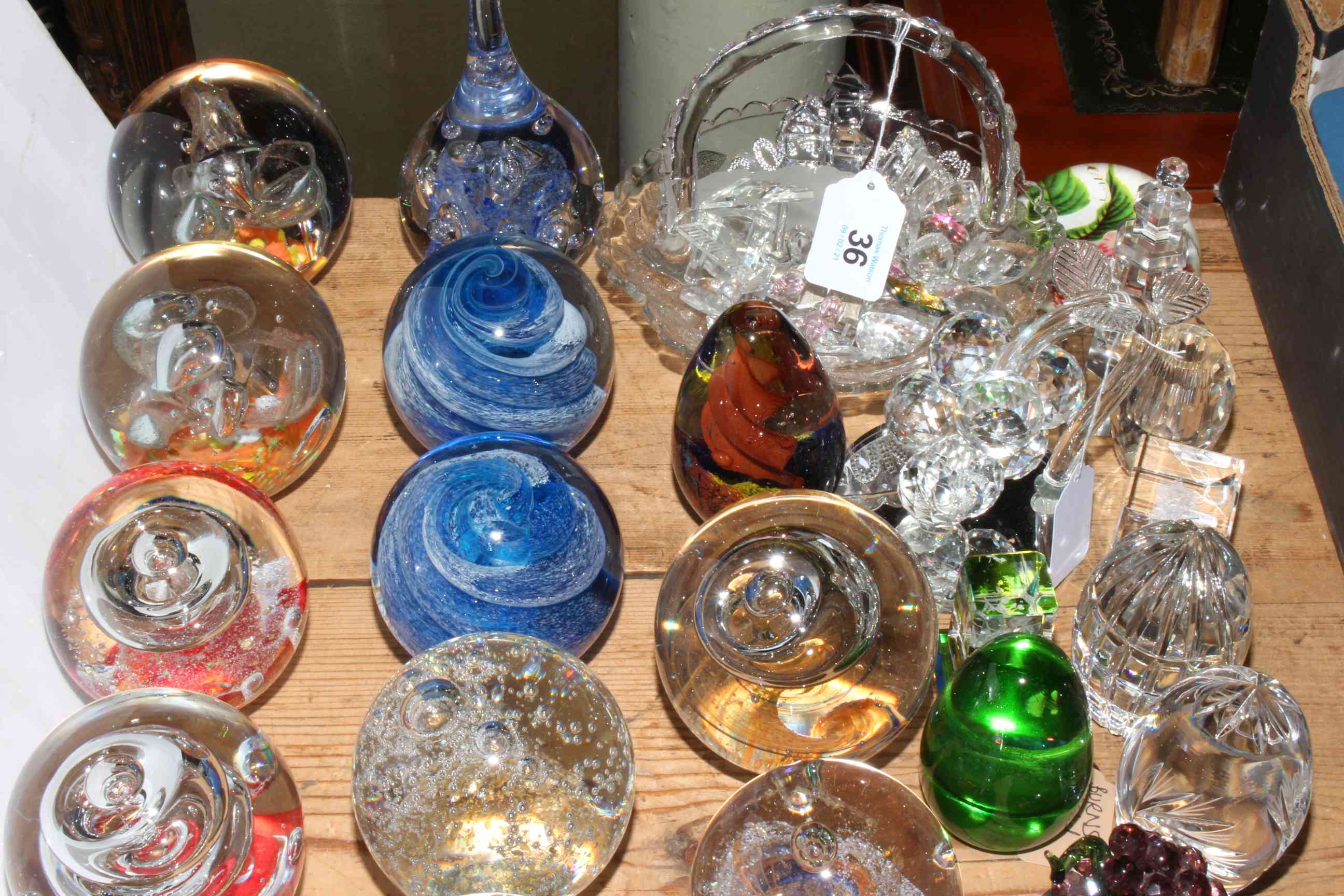 Collection of twenty six paperweights, pressed glass commemorative basket and crystal pieces.