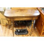 Early 19th century mahogany fold top card table on turned tapering legs.