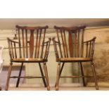 Pair of cane seat spindle arm chairs. Condition: Wear from usage with varnish loss.