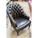 Brown leather deep buttoned back tub chair raised on turned mahogany legs.