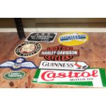 Eight cast metal advertising signs including Guinness, Harley Davidson, Michelin, RAF, etc.