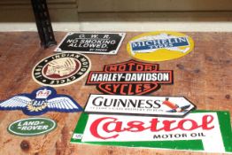 Eight cast metal advertising signs including Guinness, Harley Davidson, Michelin, RAF, etc.