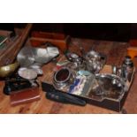 Box with silver plated wares, five board games, kitchen scales, food slicer, and camera tripod.