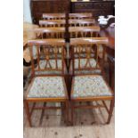 Set of eight inlaid mahogany dining chairs with upholstered and studded seats.