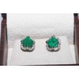 18 carat white gold and emerald ring and earrings,