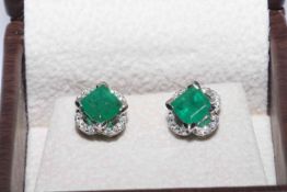 18 carat white gold and emerald ring and earrings,