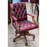 Red deep buttoned leather swivel office chair.