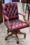 Red deep buttoned leather swivel office chair.