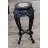 Oriental circular carved hardwood and marble inset top jardiniere stand, 68cm by 28cm diameter.