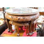 Circular nest of five heavily carved camphor wood tables.