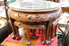 Circular nest of five heavily carved camphor wood tables.