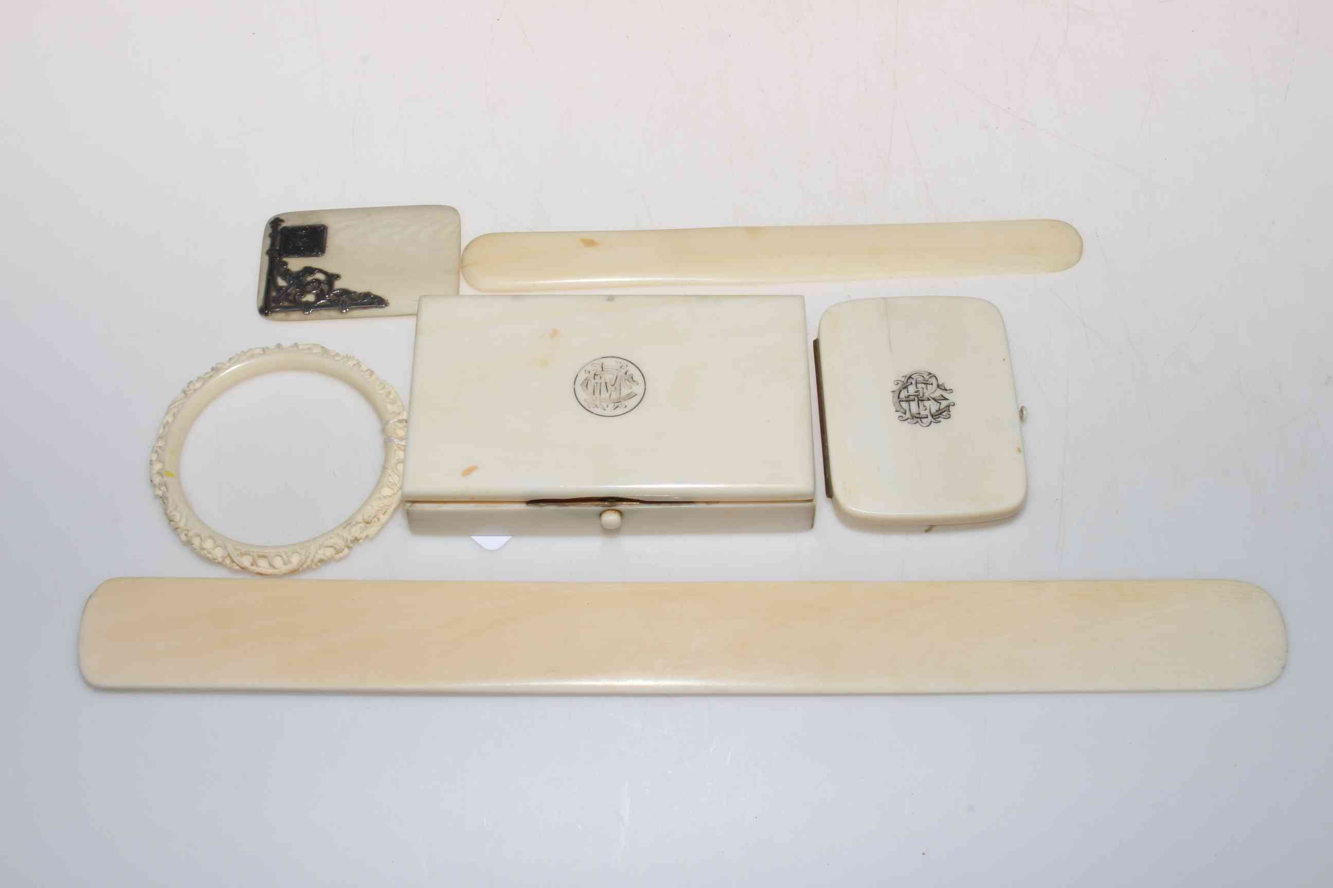 Six pieces of antique ivory, comprising silver mounted case front, monogrammed box and photo frame,