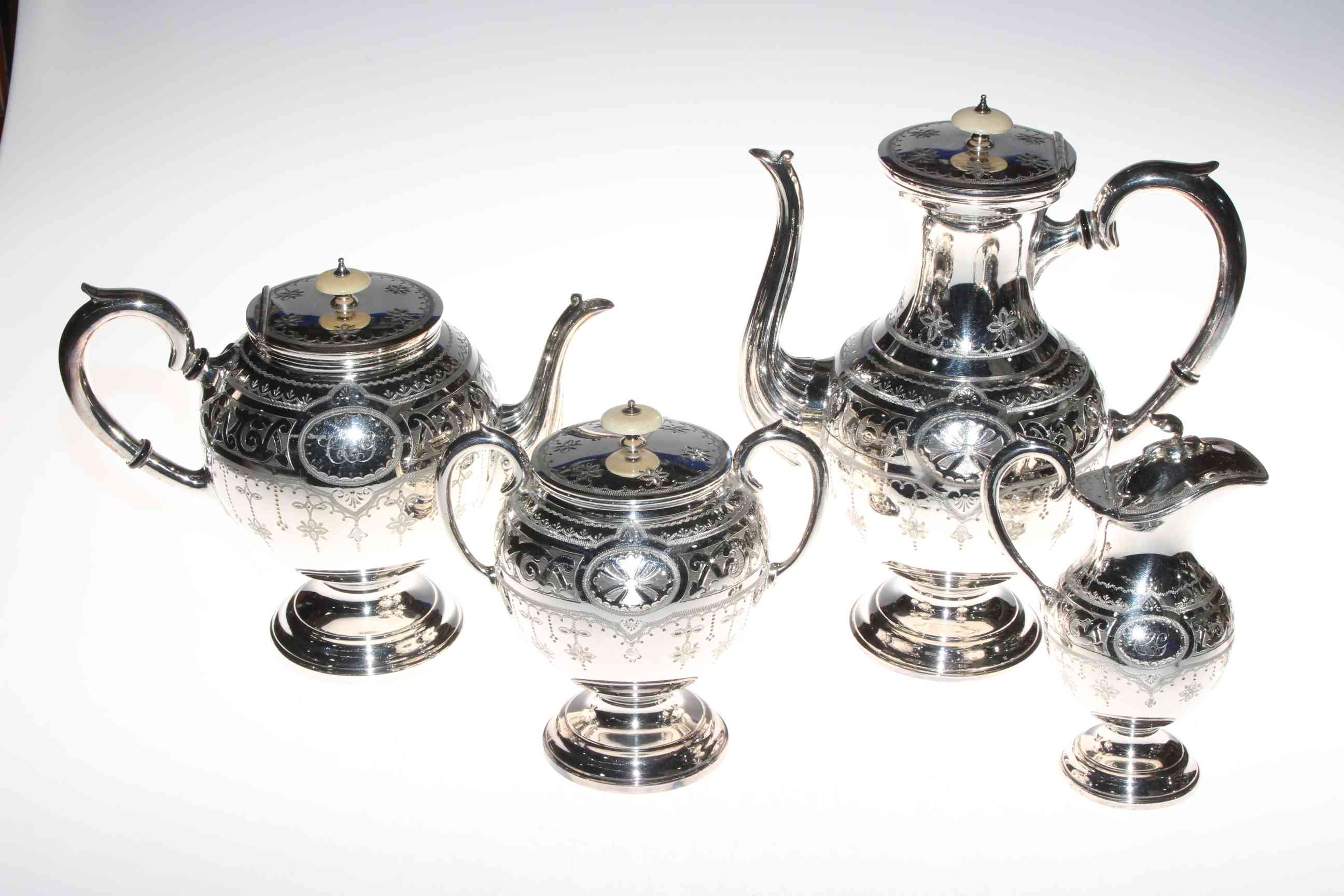 Late Victorian impressive silver plated four piece tea and coffee service having engraved