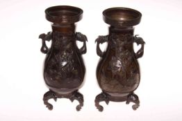 Pair bronze two handle vases with gilt highlighted relief panels of birds and blossom and on