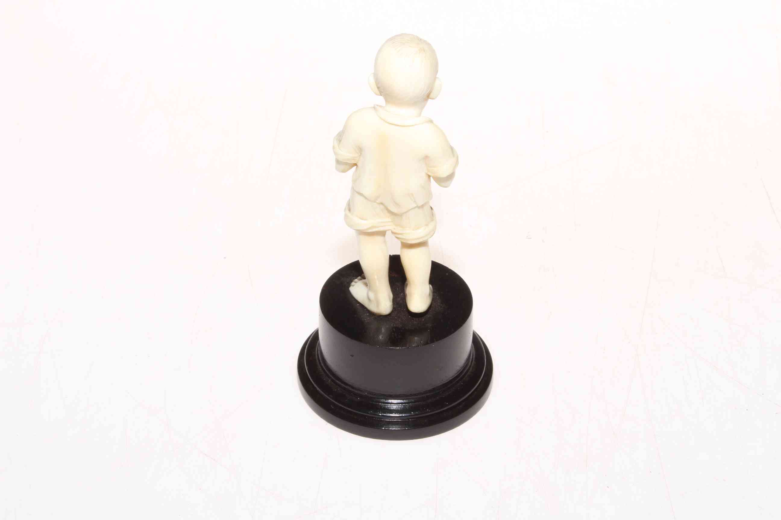 1920's well carved ivory figure of young boy with fish, on plinth base, 13cm. - Image 2 of 2