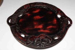 Oriental etched metal circular tray and carved hardwood Chinese dragon tray.