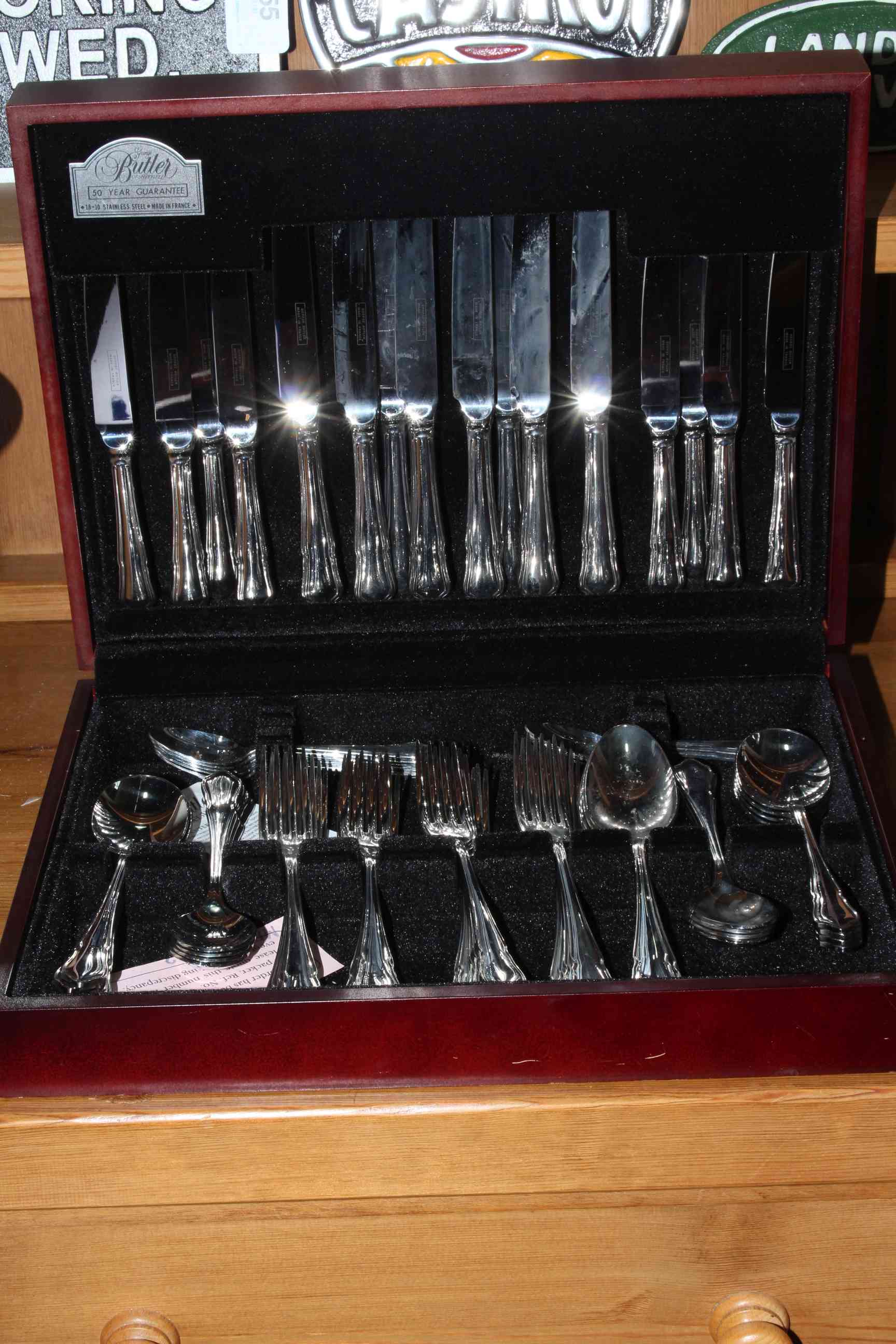 Butler canteen of cutlery in mahogany finish case.
