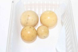 Four 19th Century ivory billiard balls.