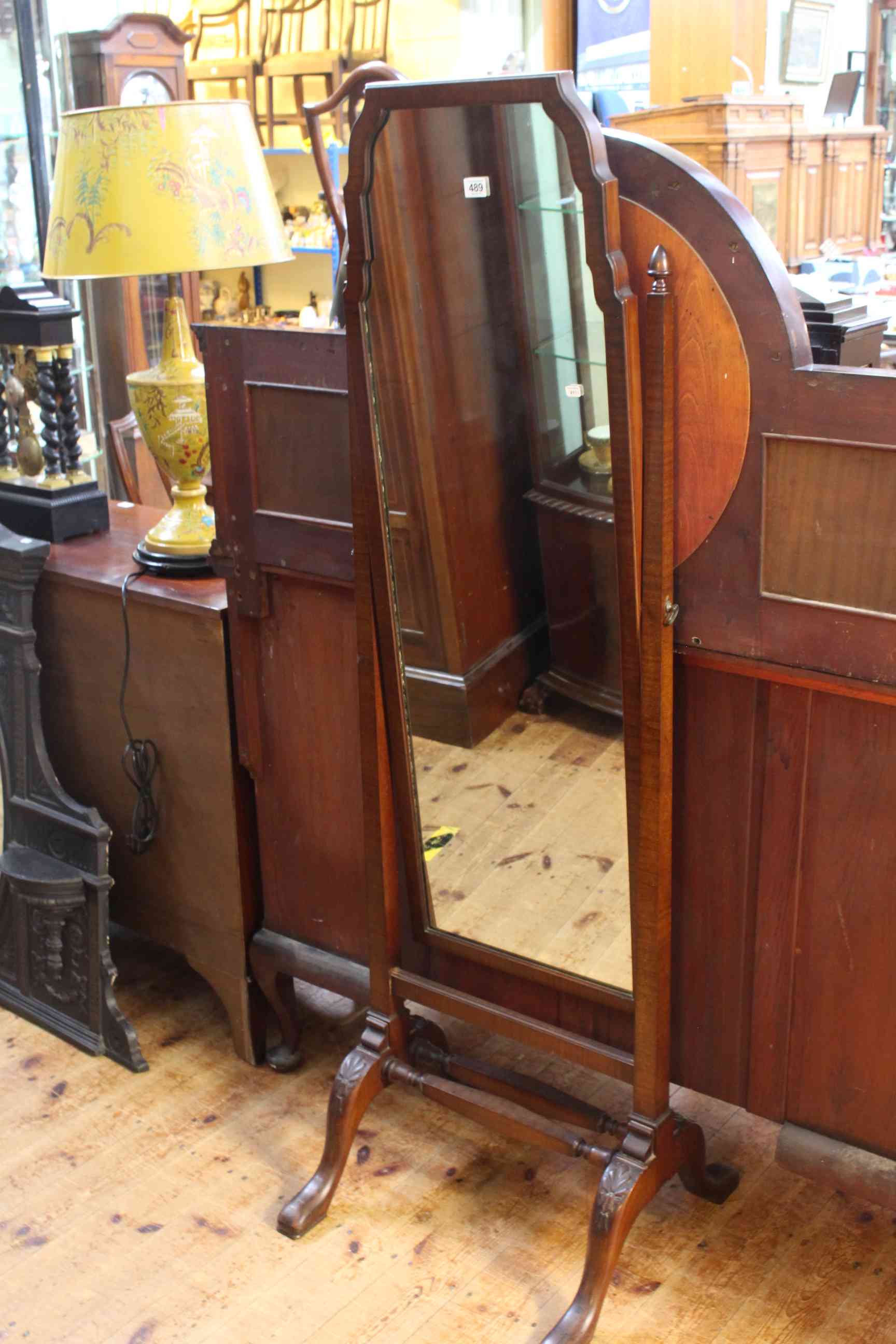 Mahogany cheval mirror raised on square tapering supports.