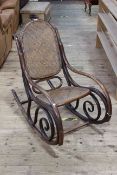 Bentwood rocking chair with bergere panel back and seat (numerous splits in wood).